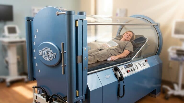 A patient relaxing inside a hard-shell hyperbaric oxygen chamber at HBOTQ